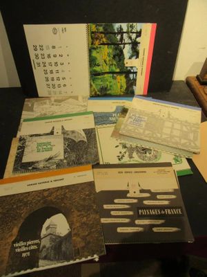 a lot of books on a table with a calendar on it