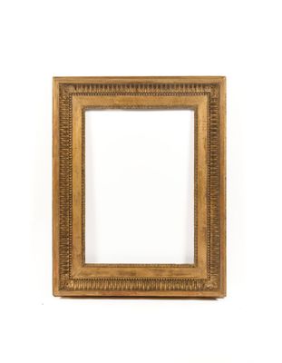 an antique gold frame with a decorative pattern on a white background