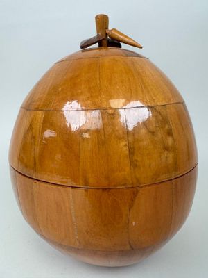 a wooden box with a bird on top of it