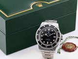 a rolex watch in a green box with a wax seal