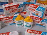 several boxes of different types of toothpaste on a table