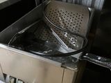 a deep fryer in the middle of a kitchen