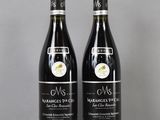 two bottles of wine sitting on top of a table next to each other