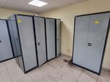 four lockers in a room with a fire hydrant in the corner