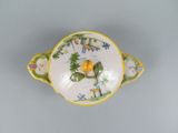 a small bowl with a bird on it on a table