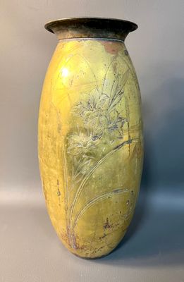 a yellow vase sitting on a table with a white background