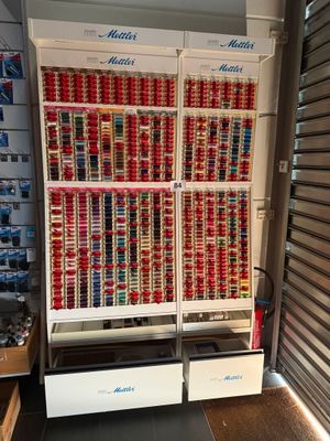 many cans of soda stacked on the shelves in the store