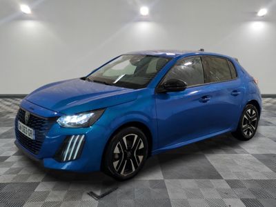 a blue car is parked on a checkered floor in a garage