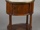 a small round table with a marble top and brass trim