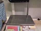 a scale that is sitting on a counter with a calculator in front of it