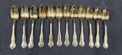 six spoons are lined up in a row on a table
