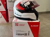 a helmet sitting on top of a box on the floor