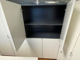 a view of a kitchen with white cupboards and a wooden floor