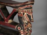 an image of a wooden bench with a painted face on it