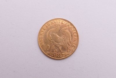 l'image d'une pièce d'or posée sur une surface blanche