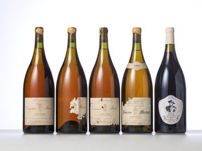 six bottles of wine are lined up on a table