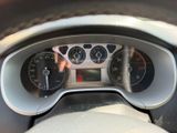 a close up of a car dashboard with a speedometer and gauges