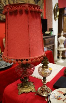 a table with a red table cloth and a lamp on it