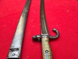 two old swords are on a red cloth on a table