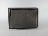 an old black camera sitting on top of a table