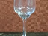 a clear wine glass sitting on a marble table