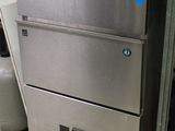 a stainless steel refrigerator in the corner of a room