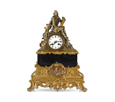 a clock that is sitting on a stand with a statue on top of it
