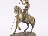 statue of a man on a horse with a flag on a base