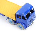 a toy truck that is blue and yellow on a white background