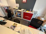 a desk with a chair and a computer on it