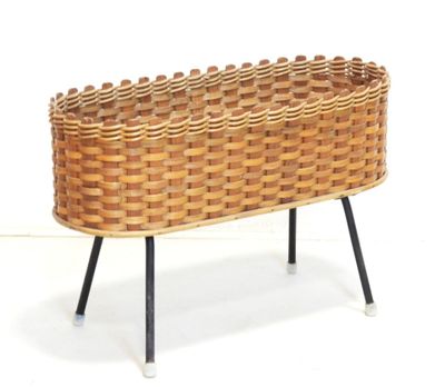 a wicker basket that is sitting on a stand