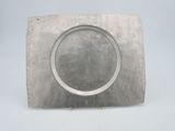 a silver plate with a circular design on it