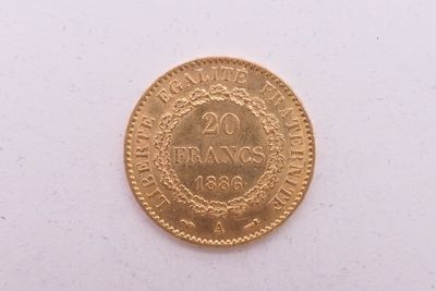 gros plan d'une pièce d'or sur une surface blanche