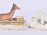 two figurines of animals sitting on top of each other