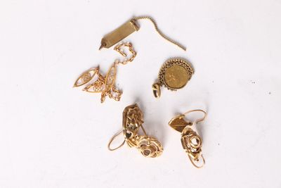 a lot of gold jewelry on a white surface