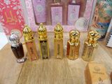 several bottles of perfume are lined up on a wooden table