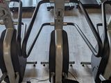 a row of stationary exercise bikes in a gym