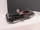 a black toy car sitting on top of a white box