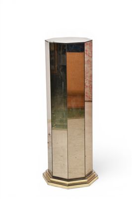 an image of a tall silver vase sitting on top of a table