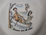 a plate with a picture of a man and a woman in a boat