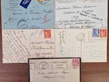 several old envelopes are sitting on top of a wooden table