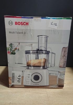 une boîte contenant un mixeur posée sur une table en bois