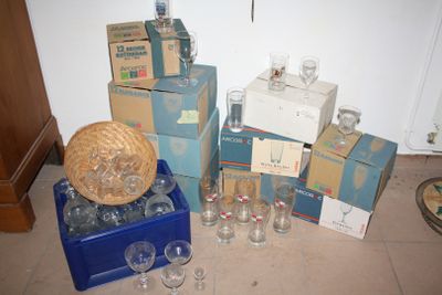 many boxes of wine glasses and a basket on the floor