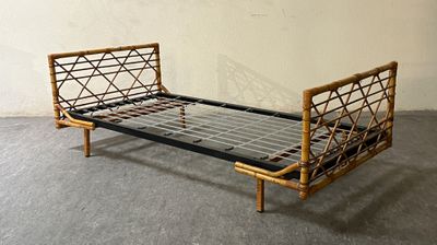 a bed that has a metal frame on it