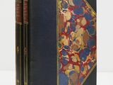 a black book with a red and blue cover and gold trim