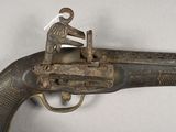 an old gun with a man sitting on top of it