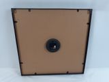 a close up of a brown box with a button on it