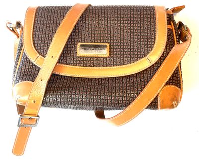 brown and black handbag with tan leather strap on a white background