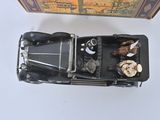 a black toy car with a box on the table
