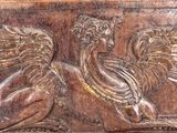 a wooden plaque with a bird and a bird on it